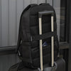 The Canyon Backpack on top of luggage, held in place by the Canyon's built-in trolley strap. This photo also shows the hidden anti-theft pocket underneath the trolley strap